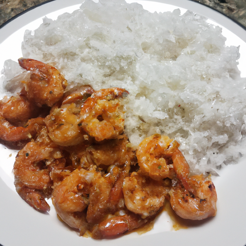 A plate of spicy garlic shrimp with a side of white rice